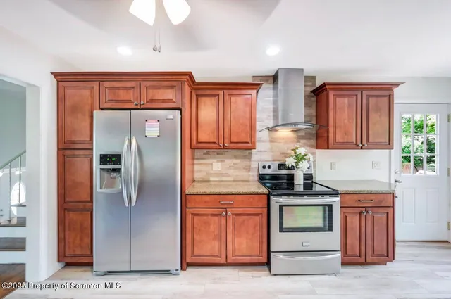 a view of a room with wooden floor ceiling fan and window