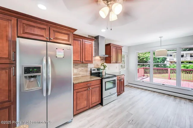 a view of a room with wooden floor and chandelier