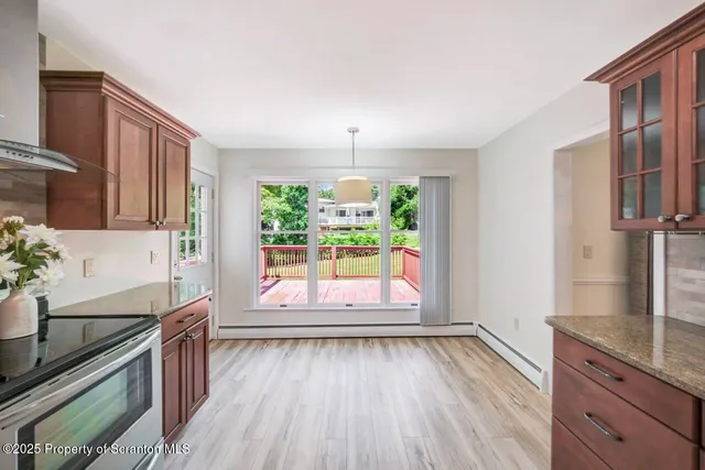 a view of a room with wooden floor and windows