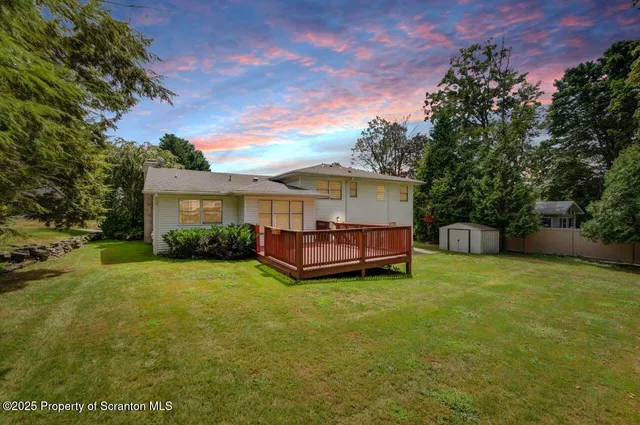 a view of a house with a yard and sitting area