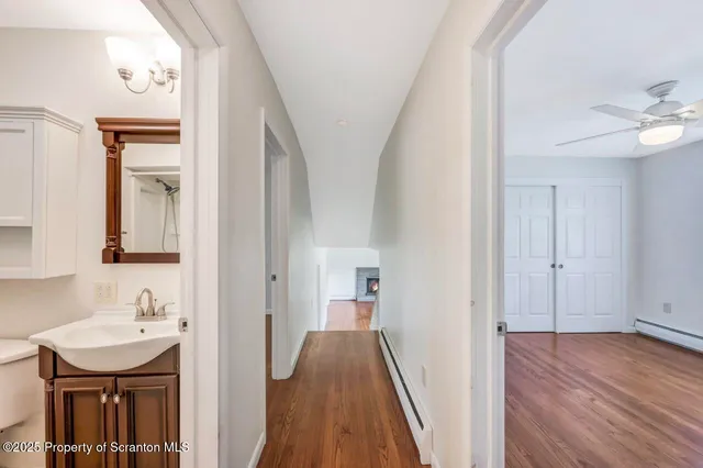 a view of a hallway with wooden floor