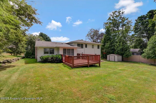 a view of a house with a yard and sitting area