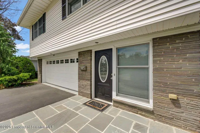 a view of entryway with hall and wooden floor