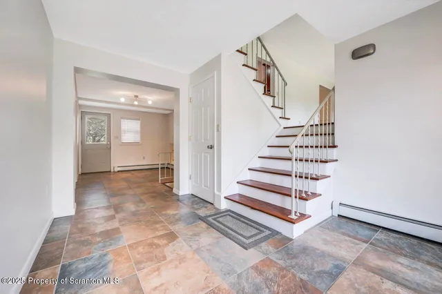 a view of entryway and hall with wooden floor