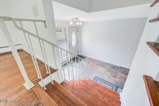 a view of empty room with wooden floor and fireplace