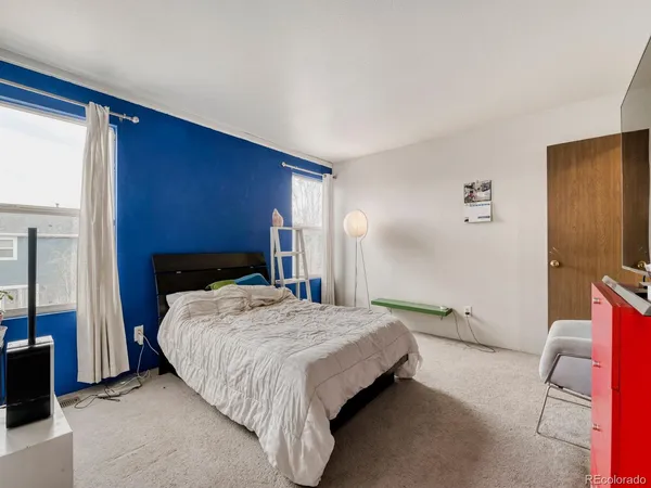 a bedroom with a bed and a chair