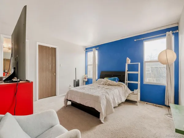 a bedroom with a bed and window