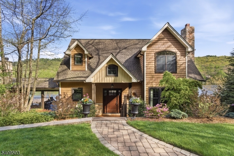 89 Woods Road Branchville, NJ 07826 - Photo 2 of 49 a front view of a house with a garden and plants