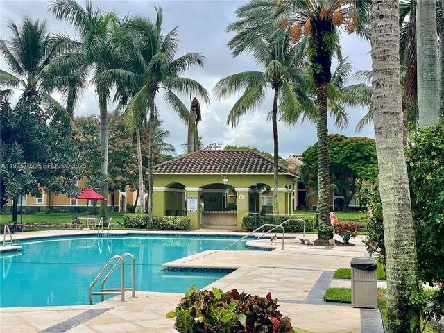 a view of a swimming pool with a table and chairs