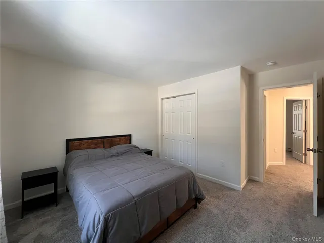 a bedroom with a bed and a night stand