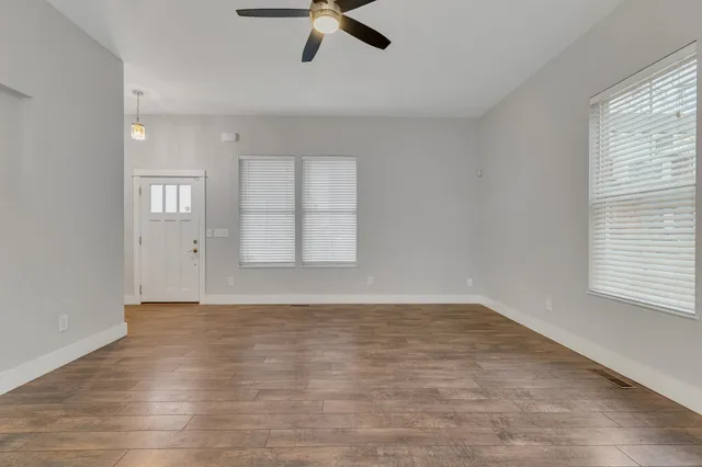 wooden floor in an empty room with a window