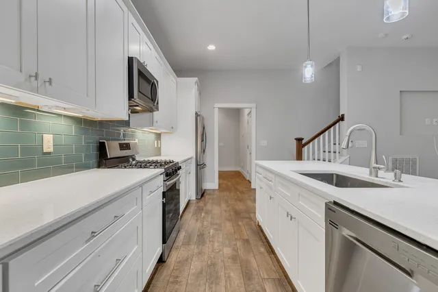 a kitchen with a sink stove and cabinets