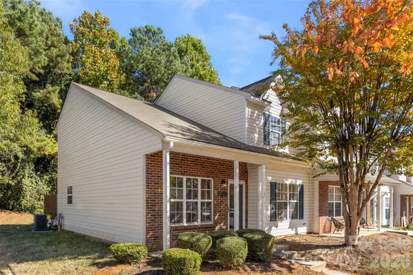 front view of a house with a tree