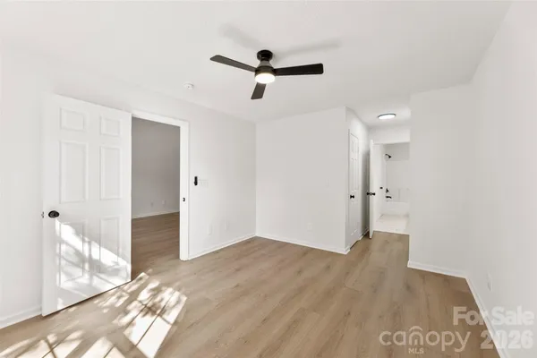 a view of empty room with wooden floor