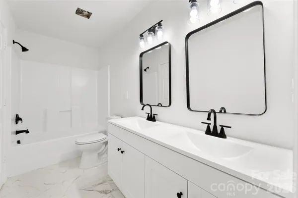a bathroom with 2 sink and a mirror