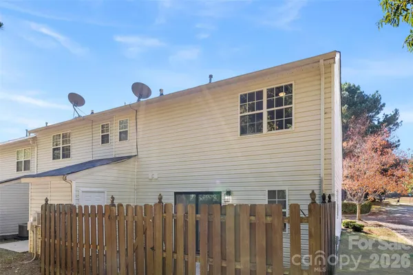 a front view of a house with wooden fence