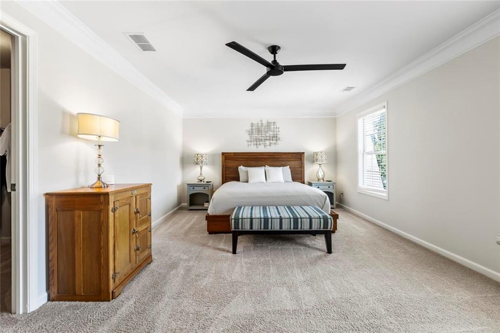 2426 Fair Oaks Way Atlanta, GA 30337 - Photo 17 of 29 a spacious bedroom with a bed and a lamp