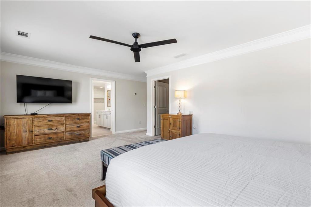 2426 Fair Oaks Way Atlanta, GA 30337 - Photo 18 of 29 a spacious bedroom with a bed and a flat screen tv