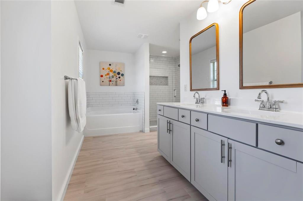2426 Fair Oaks Way Atlanta, GA 30337 - Photo 19 of 29 a bathroom with a double vanity sink a mirror and a shower