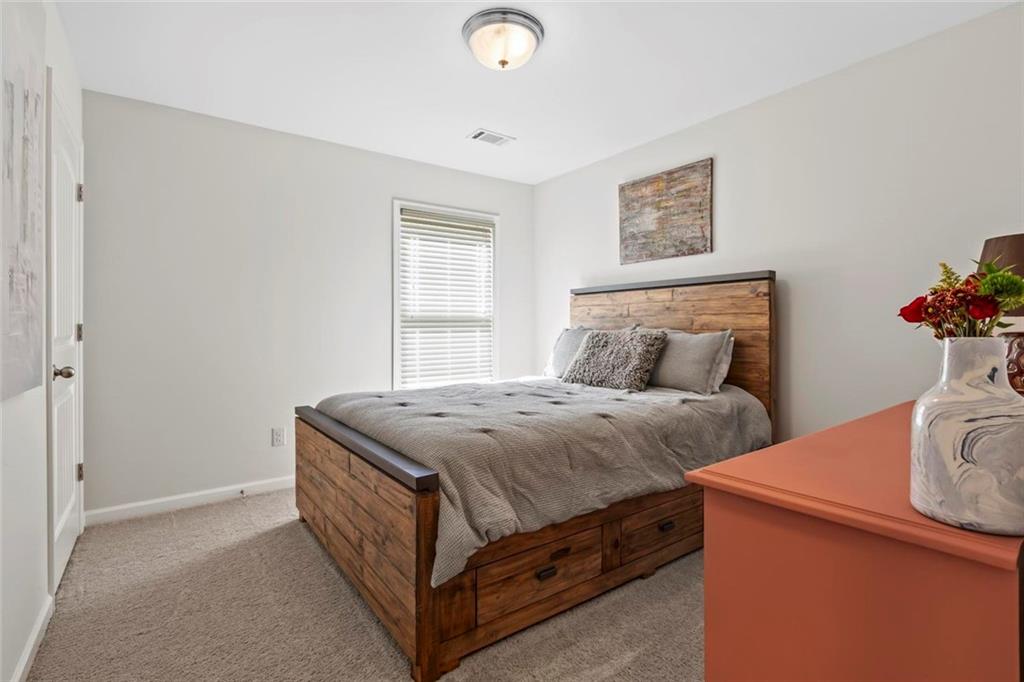 2426 Fair Oaks Way Atlanta, GA 30337 - Photo 21 of 29 a bedroom with bed and a window