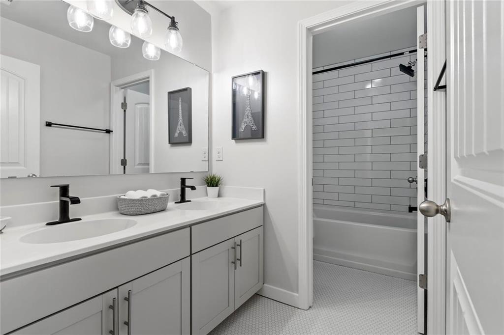 2426 Fair Oaks Way Atlanta, GA 30337 - Photo 24 of 29 a bathroom with a double vanity sink a mirror and shower