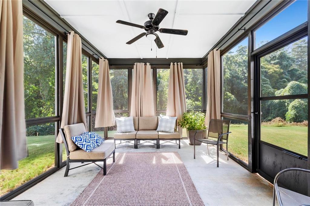 2426 Fair Oaks Way Atlanta, GA 30337 - Photo 27 of 29 a living room with furniture and floor to ceiling windows