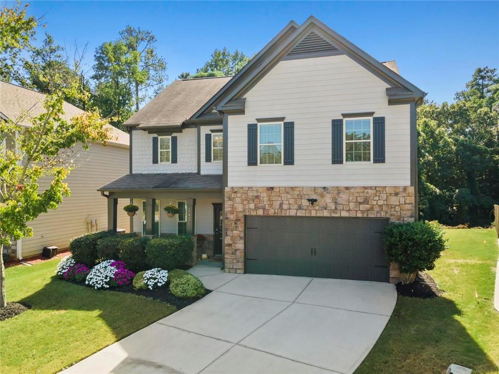 2426 Fair Oaks Way Atlanta, GA 30337 - Photo 3 of 29 a front view of a house with a garden and plants