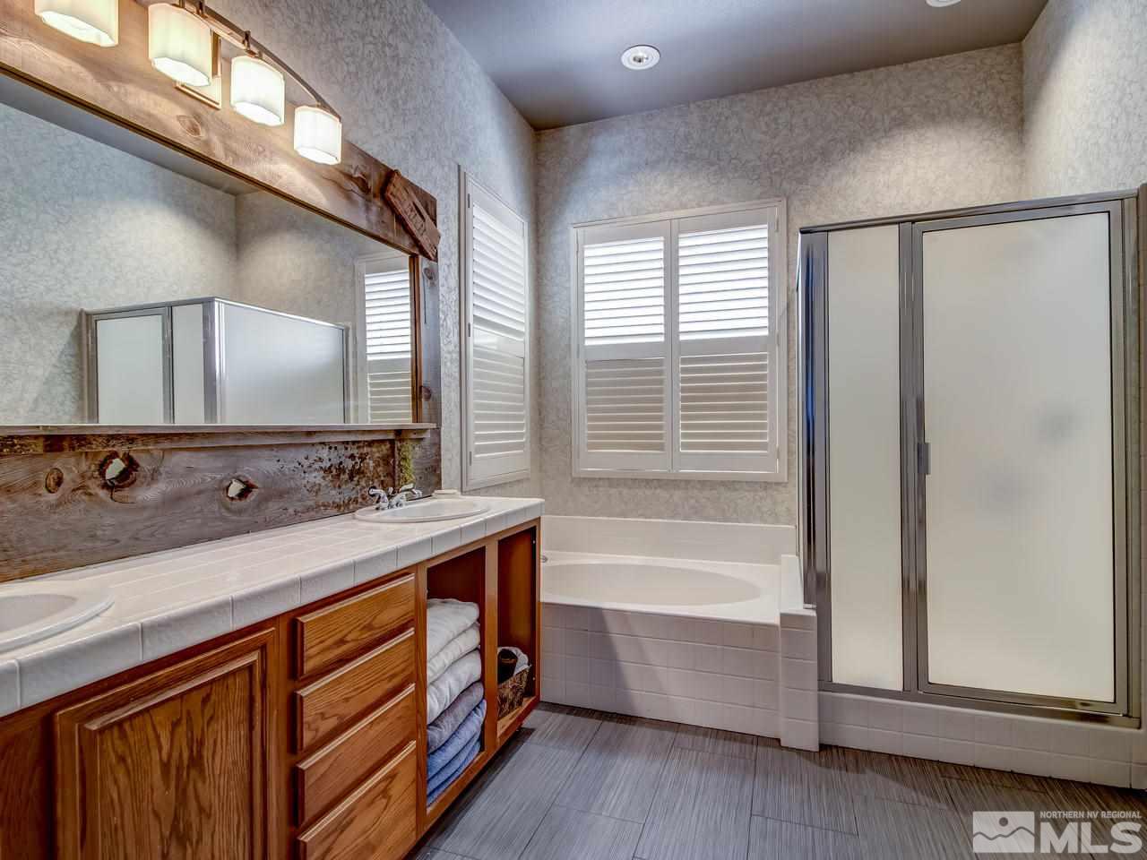 1614 Commonwealth Circle Reno, NV 89503 - Photo 13 of 21 a bathroom with a tub sink and mirror