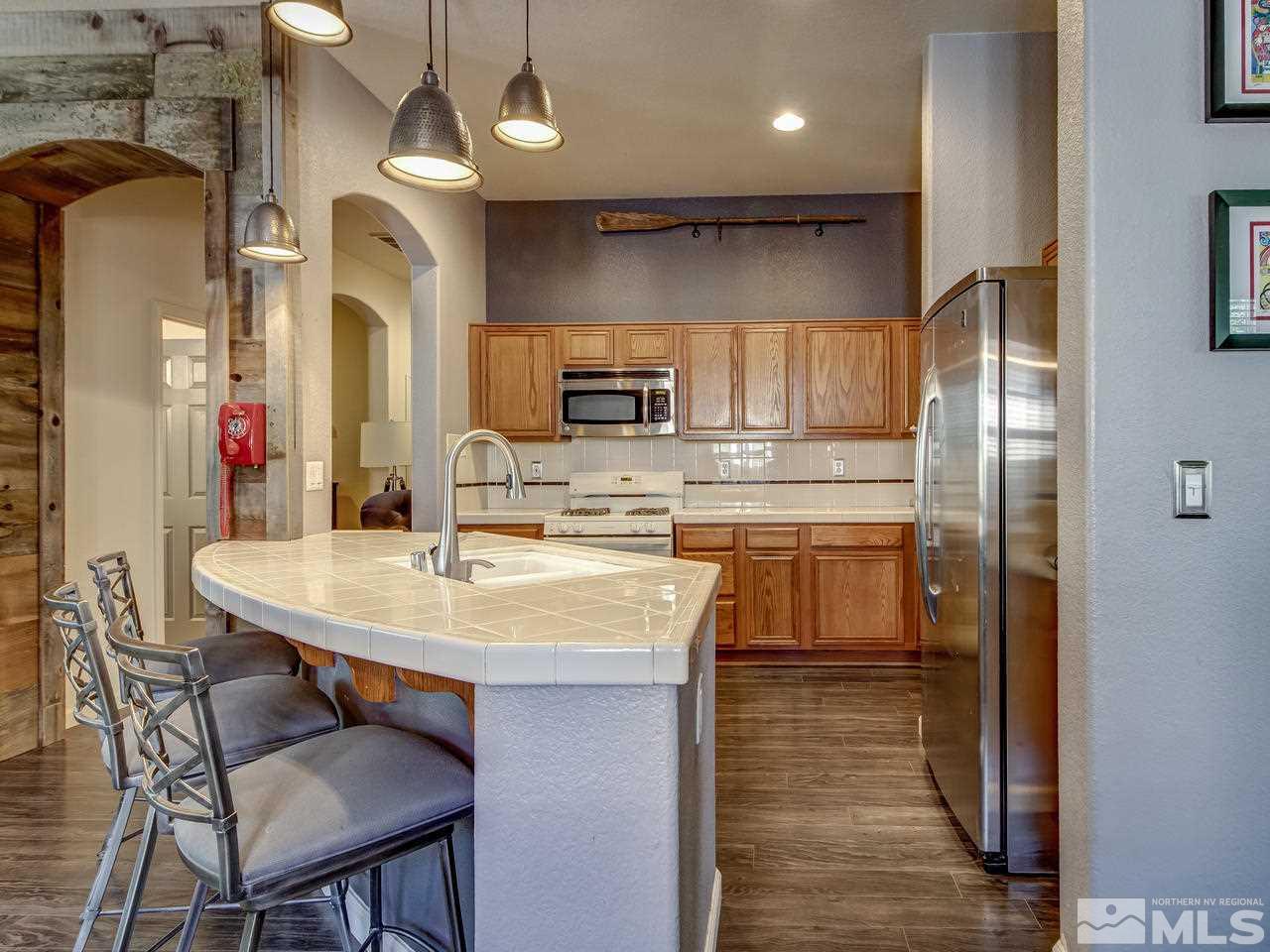 1614 Commonwealth Circle Reno, NV 89503 - Photo 10 of 21 a kitchen with cabinets a sink stainless steel appliances and kitchen view