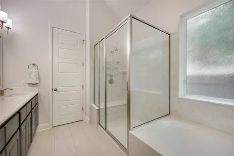 a bathroom with a shower sink and mirror