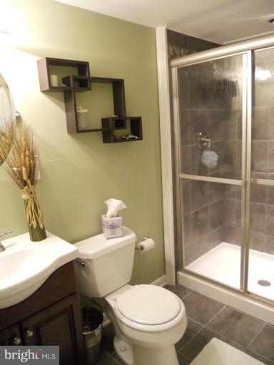 9321 Pan Ridge Road, Unit 9321 Parkville, MD 21234 - Photo 3 of 30 a bathroom with a sink a toilet and shower