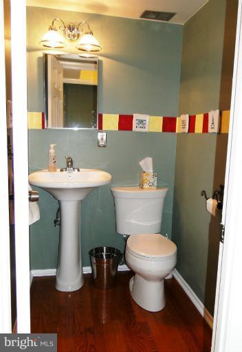 9321 Pan Ridge Road, Unit 9321 Parkville, MD 21234 - Photo 23 of 30 a bathroom with a toilet sink and mirror