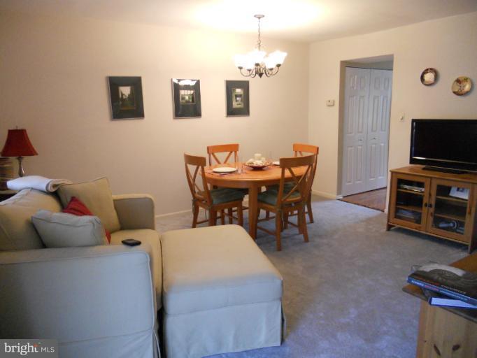 9321 Pan Ridge Road, Unit 9321 Parkville, MD 21234 - Photo 5 of 30 a view of a livingroom with furniture and a flat screen tv