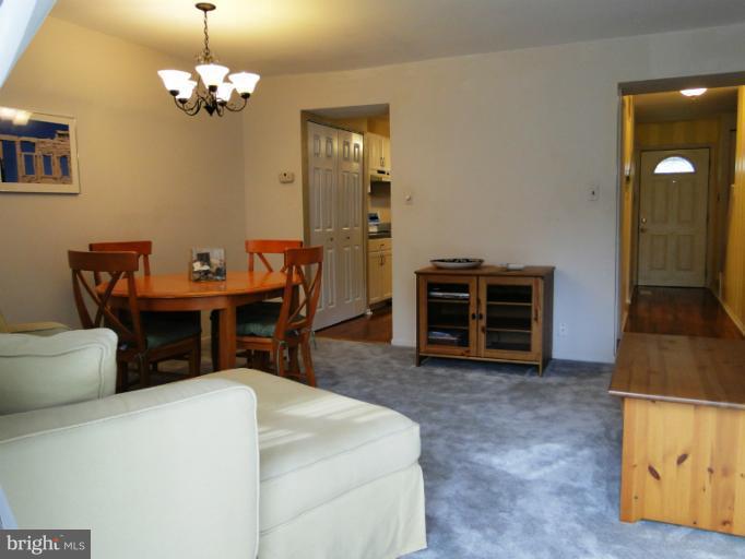 9321 Pan Ridge Road, Unit 9321 Parkville, MD 21234 - Photo 6 of 30 a dining room with furniture and chandelier