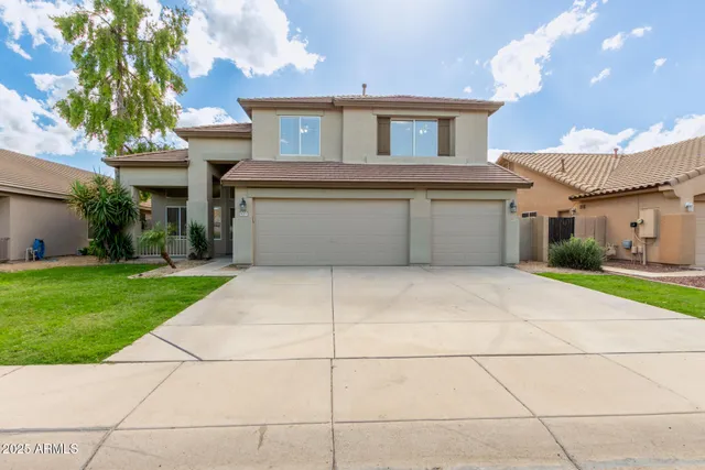 a front view of a house with a yard and a garage