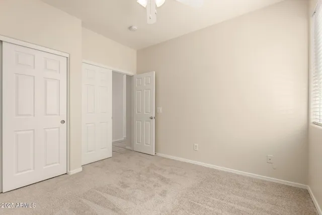 an empty room with a ceiling fan