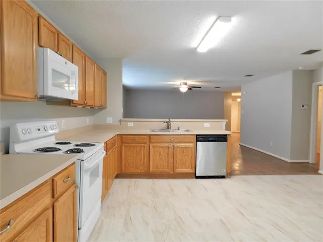 a kitchen with a stove top oven sink and cabinets
