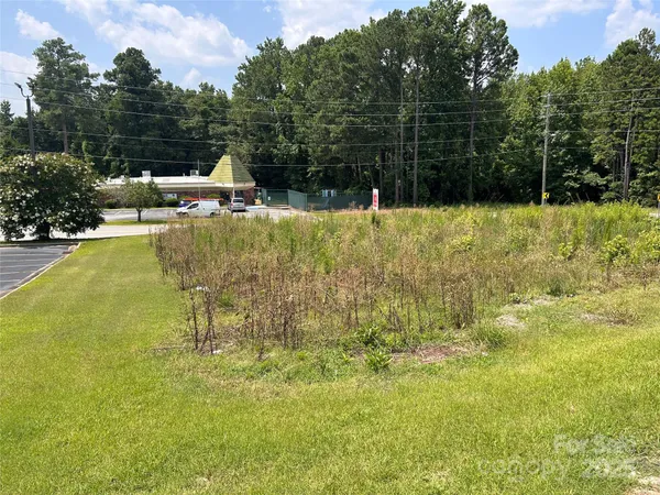 a view of swimming pool with a bench and trees
