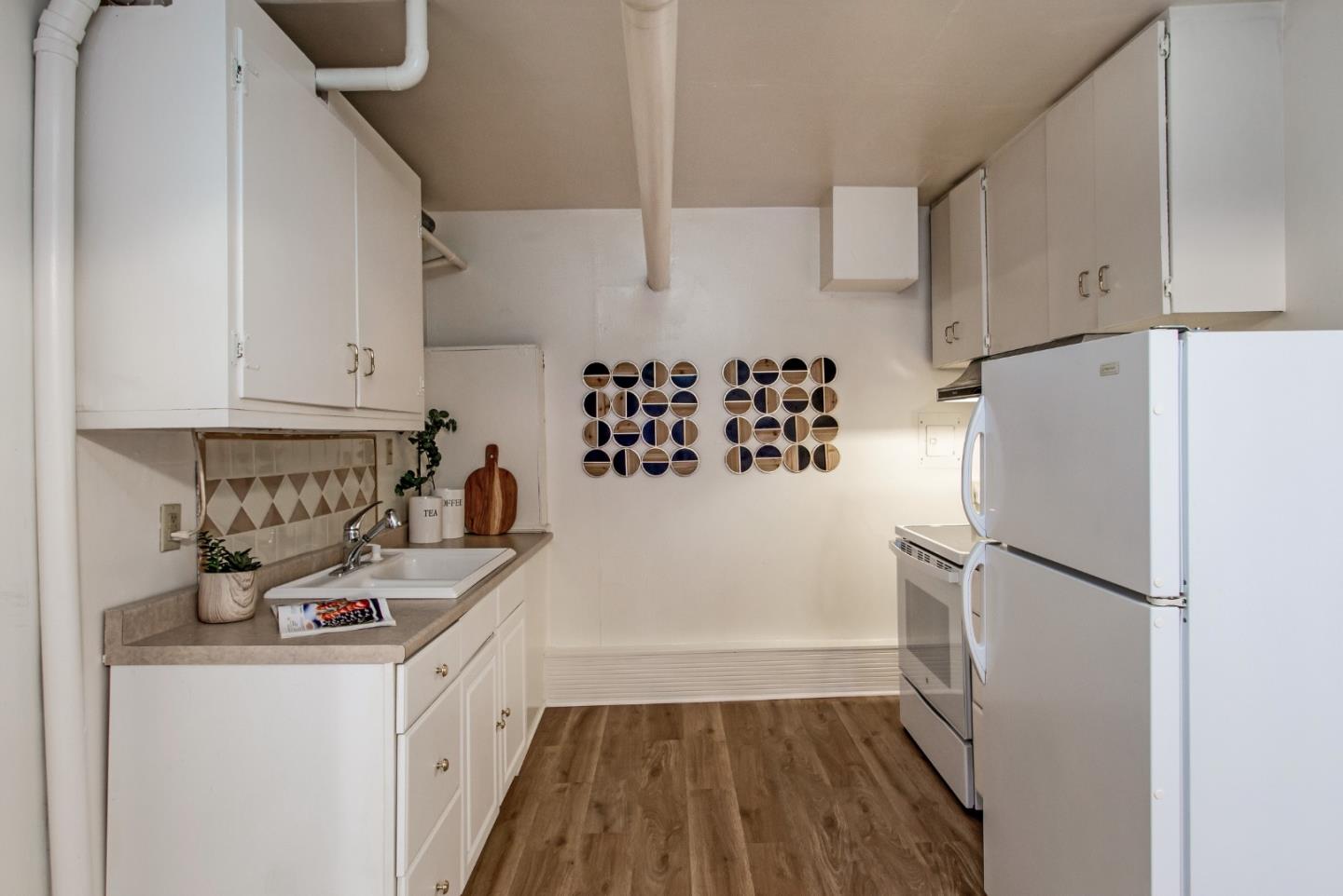 530 Summit Spring Road Woodside, CA 94062 - Photo 21 of 24 a kitchen with a refrigerator a stove and white cabinets
