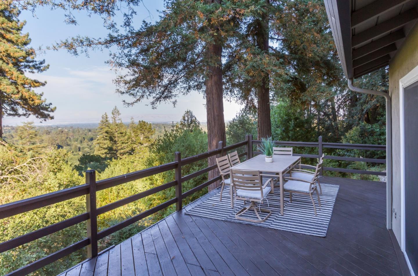 530 Summit Spring Road Woodside, CA 94062 - Photo 6 of 24 a view of a chairs and table on the wooden deck
