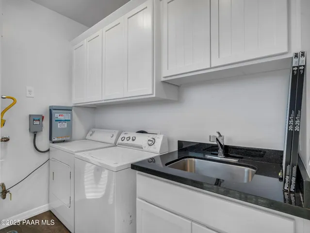 a utility room with sink dryer and washer