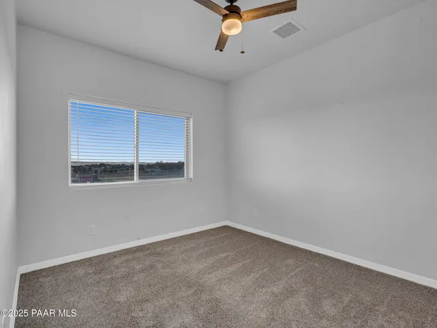 a bathroom with a granite countertop sink and a toilet