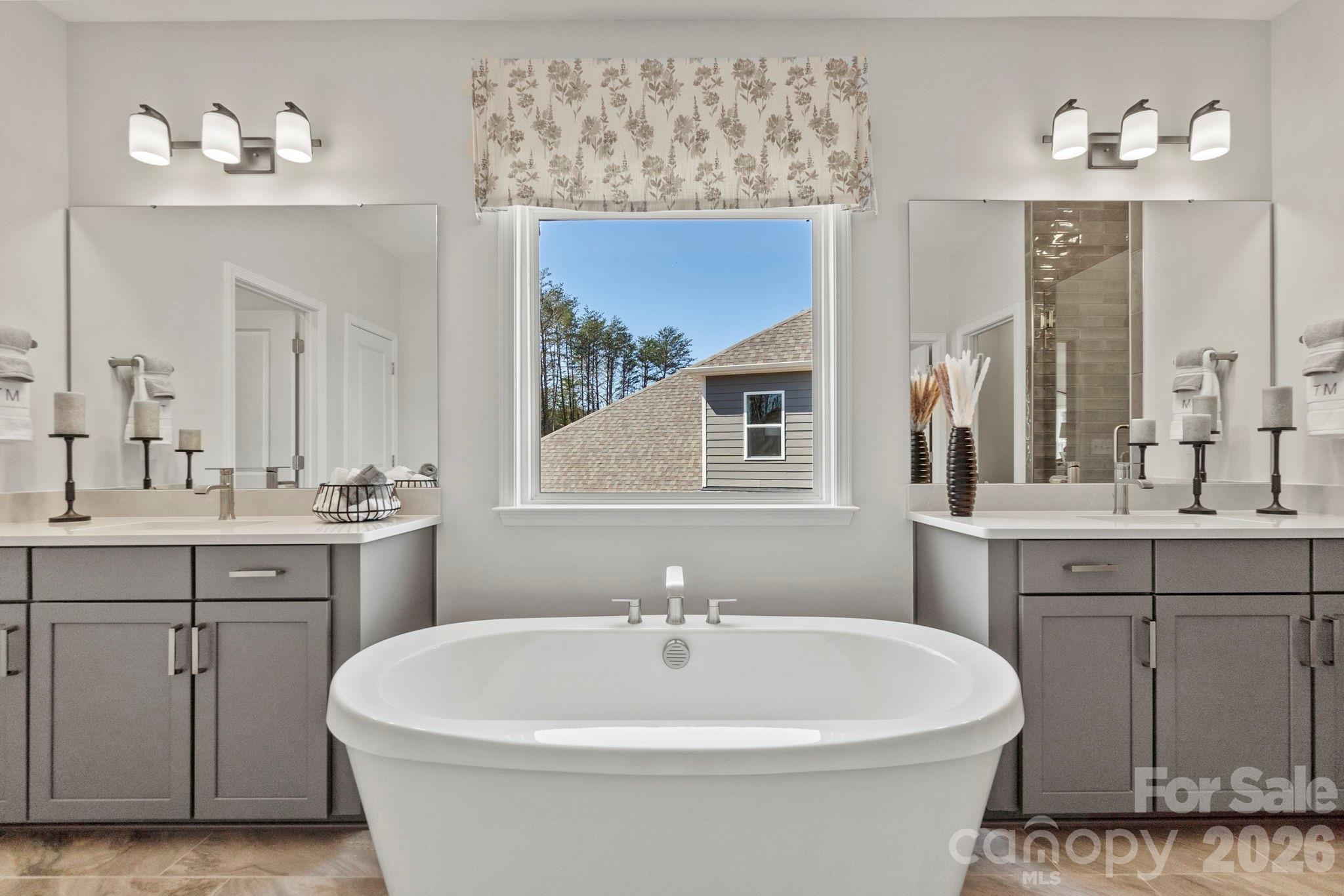 283 Stibbs Cross Road Mooresville, NC 28115 - Photo 21 of 43 a white bath tub sitting next to a bathroom sink