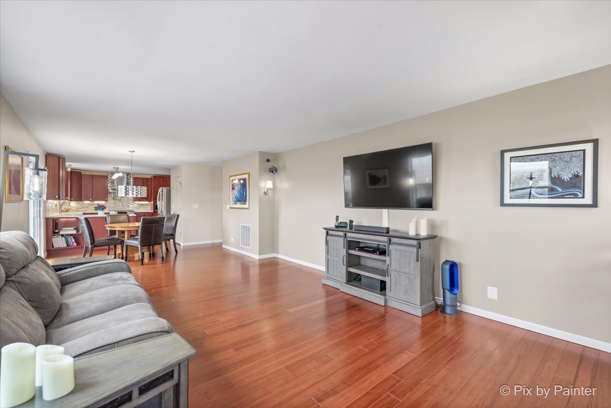 4902 Stillwater Road Wonder Lake, IL 60097 - Photo 16 of 46 a living room with furniture and a flat screen tv