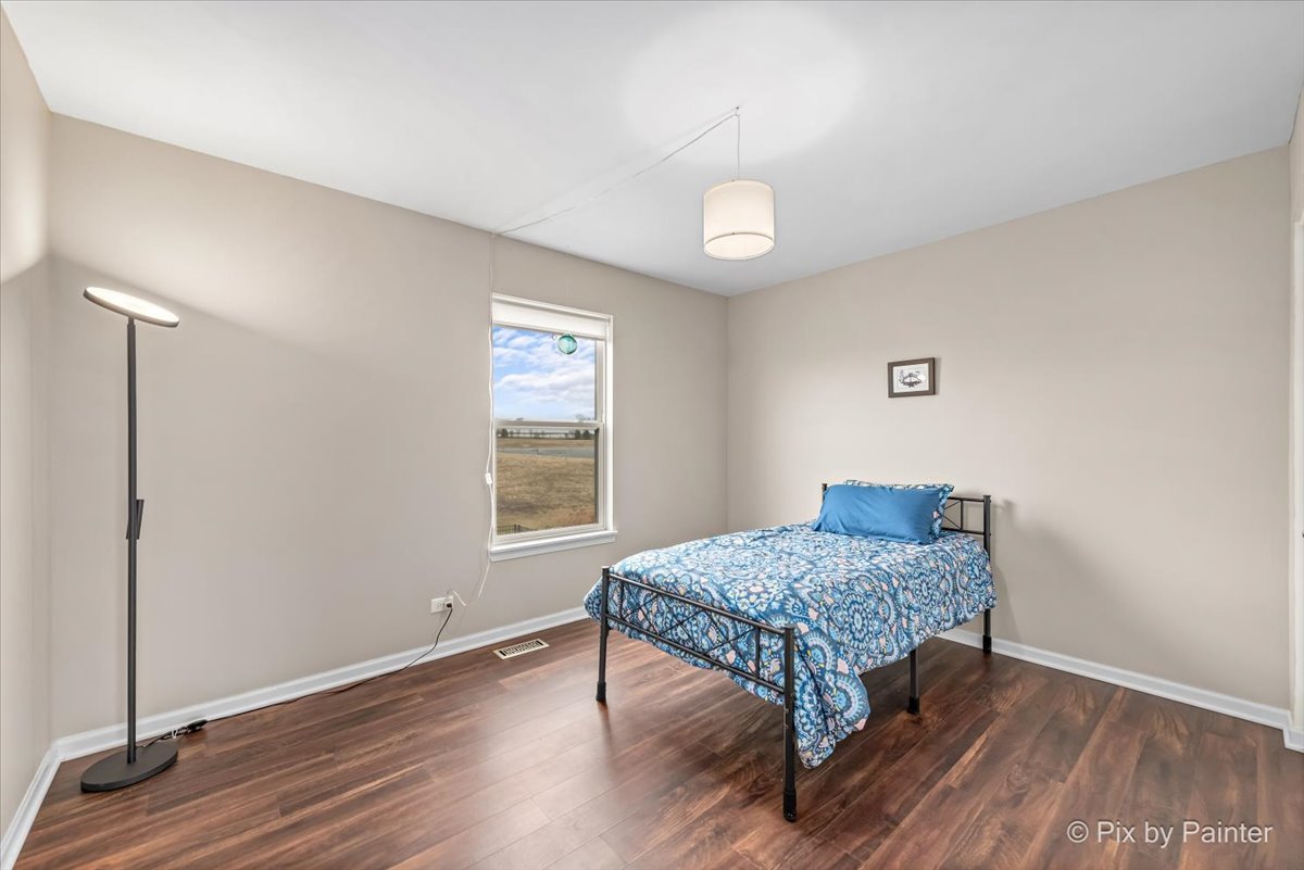 4902 Stillwater Road Wonder Lake, IL 60097 - Photo 21 of 46 a room with a table and wooden floor