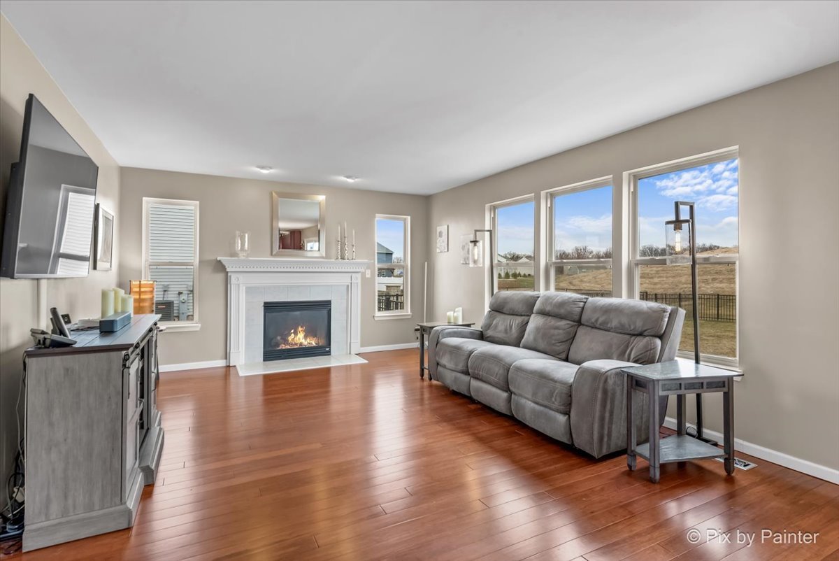 4902 Stillwater Road Wonder Lake, IL 60097 - Photo 3 of 46 a living room with furniture and a fireplace