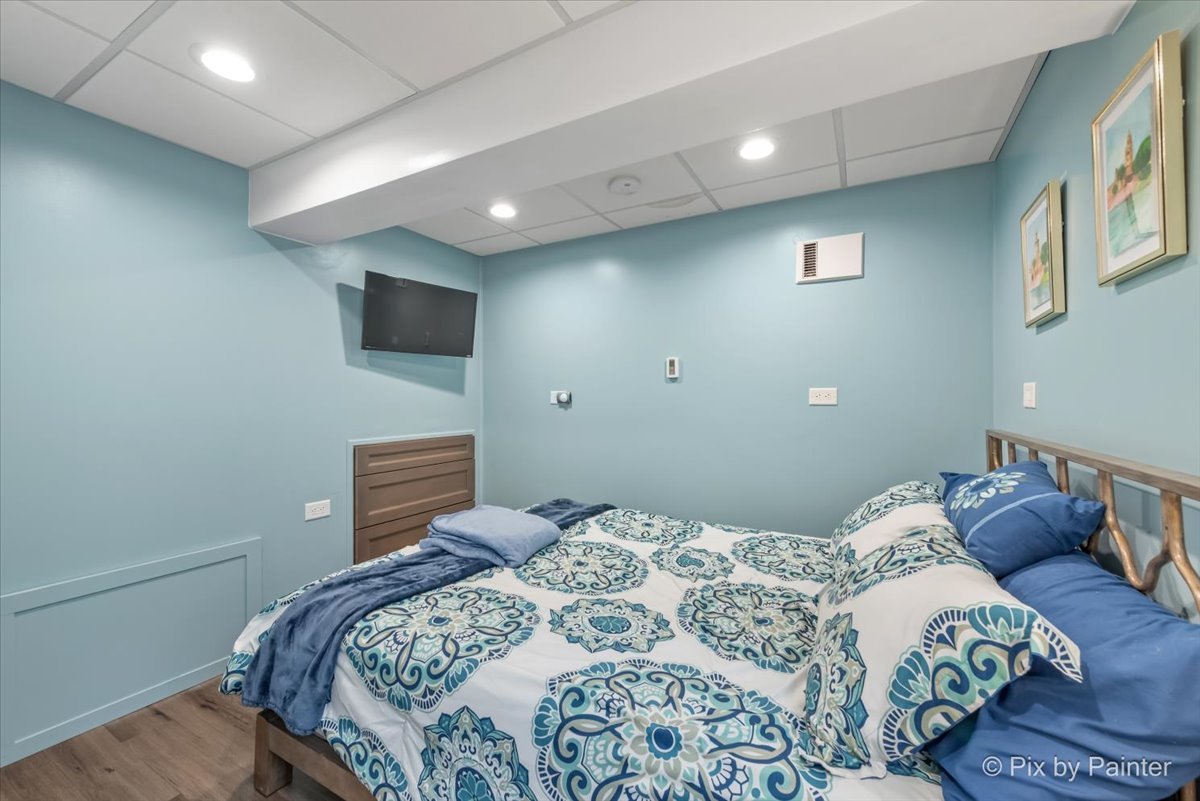 4902 Stillwater Road Wonder Lake, IL 60097 - Photo 31 of 46 a bedroom with a large bed and a flat screen tv