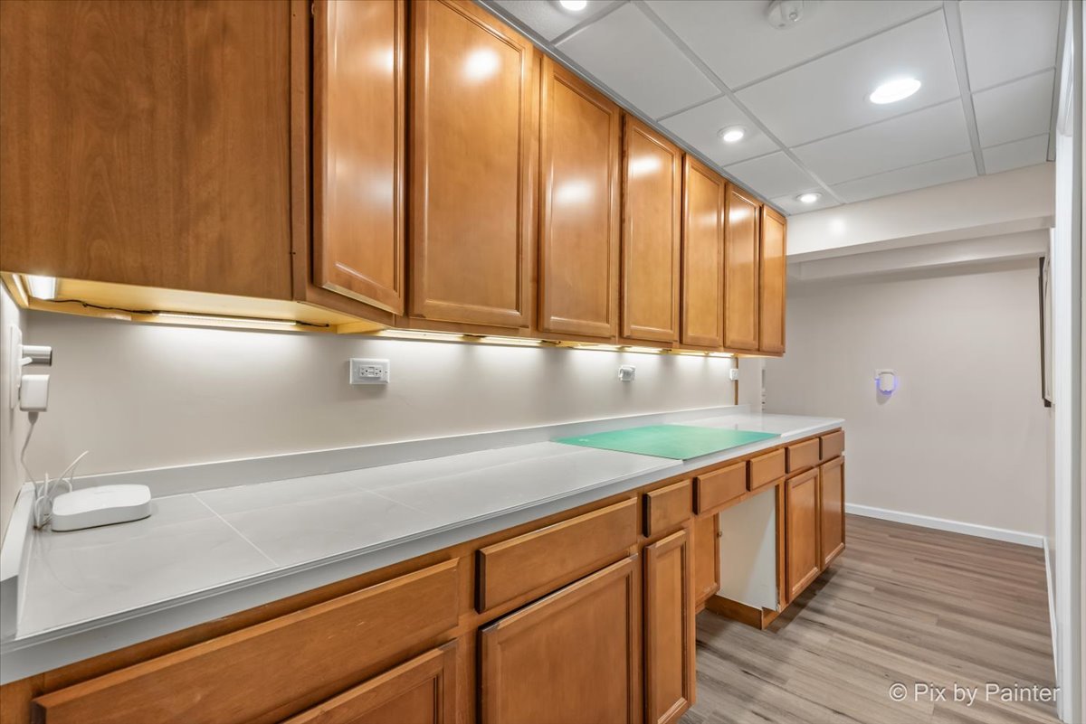 4902 Stillwater Road Wonder Lake, IL 60097 - Photo 33 of 46 a kitchen with stainless steel appliances granite countertop a sink and a wooden floors