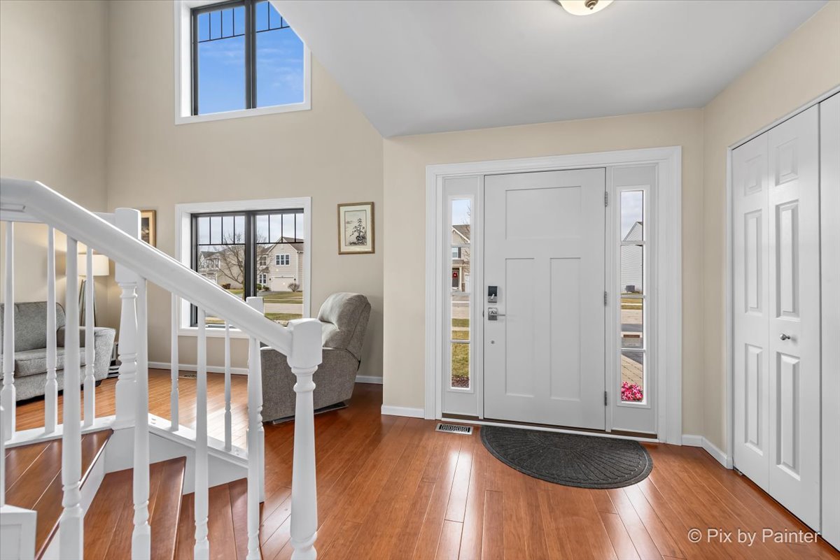 4902 Stillwater Road Wonder Lake, IL 60097 - Photo 4 of 46 a view of entryway with wooden floor and stairs