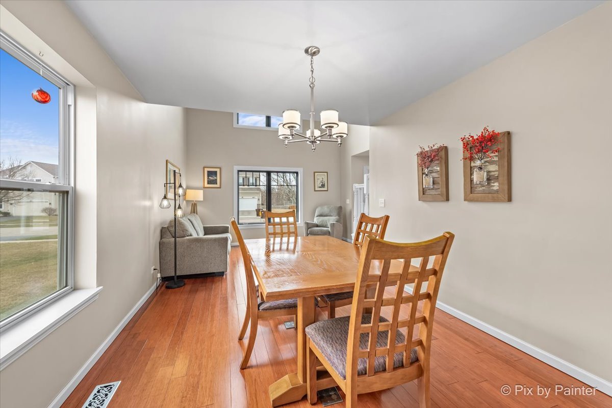 4902 Stillwater Road Wonder Lake, IL 60097 - Photo 9 of 46 a view of a dining room with furniture and wooden floor